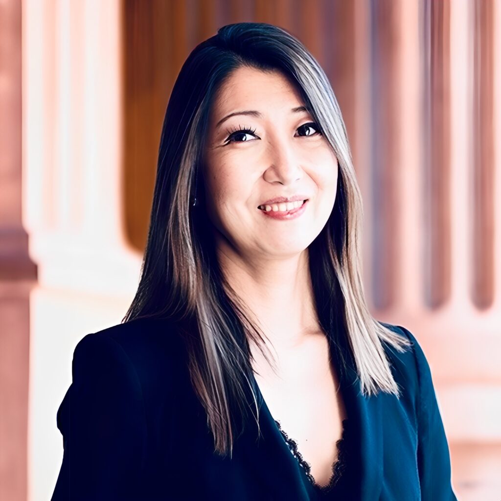 Woman in black suit smiling