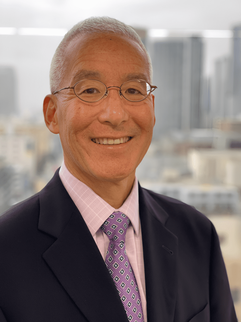 Smiling man in suit with city background